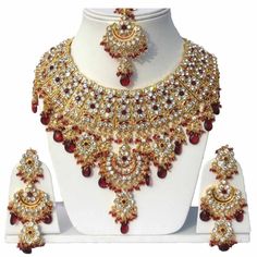 Product Description: * Gold Plated Jodha's Kundan Zerconic Bollywood Necklace Set Jewelry * The base metal color is Gold tone studded with kundan along with beads work on it. * This Jewelry set would add more charms to your beautiful jewelry collection and would surely bring lots of compliments . * Note:- This is an artificial Jewelry Set. * Care Instructions: Keep it dust-free & dirt free in a plastic pouch. Remember to apply your hairspray, perfume, and cosmetics before putting your jewellery Maang Tikka Set, Tikka Jewelry, Indian Bridal Jewelry Sets, Gold Necklace Indian, Pearl Jewelry Design, Gold Necklace Indian Bridal Jewelry, Maang Tikka, Wedding Designer, Bollywood Wedding