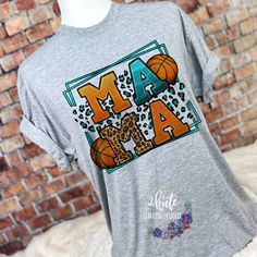 a women's t - shirt with the word maa and basketballs on it