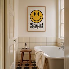 a bathroom with a smile poster above the bathtub