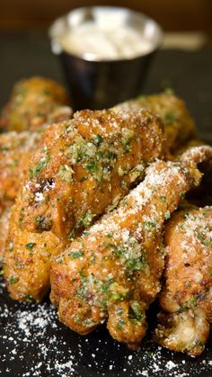 fried chicken wings with parmesan and seasoning sprinkled on the side