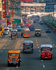 many cars are driving down the street in traffic