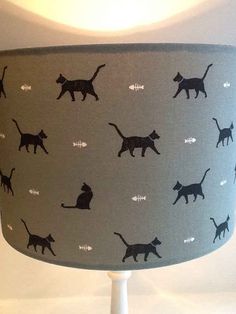 a lamp shade with black cats on it