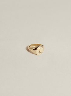 An ultra-petite version of our classic, engravable JH signet ring—interpreted in charm form. Our Baby Signet Charm has an 8mm interior diameter with a signet face that measures 5mm x 6mm. Crafted in 100% recycled 14k gold or sterling silver and available à la carte, paired with a chain (cable, figaro, or curb), or with one of our signature Charm Chains (curb, paperclip) in a length of your choosing. We offer two engraved font options for personalization: laser engraved J.H. Gothic (our entirely Timeless Engraved 14k Gold Initial Ring, Everyday Engraved Heirloom Signet Ring, Timeless 14k Stamped Initial Ring With Round Band, Timeless 14k Gold Engraved Initial Ring, Heirloom Engraved Signet Ring For Everyday Wear, Everyday Heirloom Engraved Signet Ring, Timeless 14k Gold Engraved Ring With Initials, Personalized 14k Gold Timeless Signet Ring, 14k Gold Jewelry With Initials On Round Band