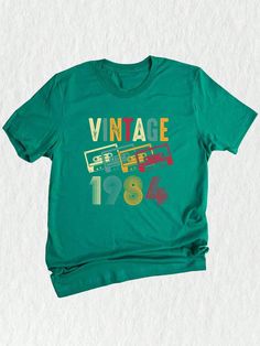 a green t - shirt with the words vintage on it and an image of a bus