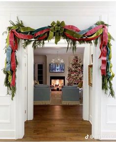 an open door with christmas decorations on the front and back doors leading into a living room