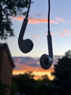 a pair of headphones hanging from the side of a window at sunset or dawn