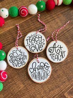 four christmas ornaments with words on them and red, white, green and blue pom - poms