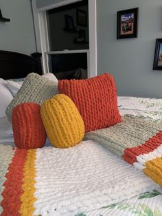 a bed with colorful pillows on top of it