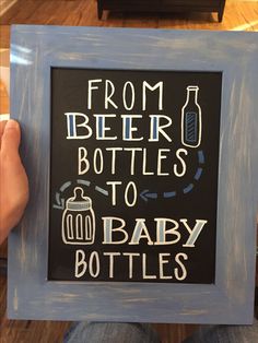 a person holding up a chalkboard sign that says from beer bottles to baby bottles