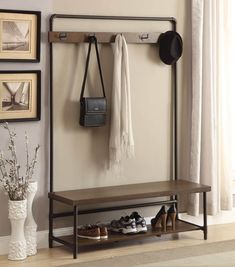 a coat rack with shoes and purses hanging on the wall next to a bench