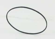 a black rubber band on a white surface