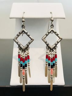 Full of color and southwestern style, these Native American-inspired dangle earrings are complete with handmade sterling silver embellishments and colorful beads.  The 5 drop bars on each earring move independently from one another. These earrings are incredibly light making them comfortable for all day wear. Native American Inspired Earrings, Glendale Az, Dragon Ring, Vintage Diamond Rings, Southwestern Style, Gorgeous Earrings, Vintage Diamond, Handmade Sterling Silver, Green And Gold