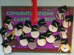 a bulletin board decorated with graduation hats