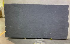 a large black marble slab in a warehouse