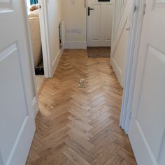 an open door leading into a bedroom with wooden floors