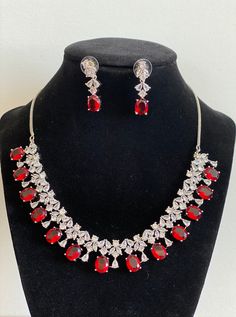 Ruby Red Necklace set with cubic zirconium stones in white gold color. It is perfect to add sparkle to your dress. Necklace Length - 16 Inches Earring Length- 1.25 Inches High Quality and Superior craftsmanship Material- Cubic Zirconium Stone, Lab Ruby Message me with any questions, I don't accept returns or exchanges on jewelry. Luxury Red Ruby Temple Necklace, Red Sparkling Crystal Jewelry, Red Rhinestone Jewelry Sets For Wedding, Red Bridal Necklace With Sparkling Stones For Wedding, Formal Red Sparkling Jewelry, Red Cubic Zirconia Jewelry Sets For Celebration, Hand Set Cubic Zirconia Bridal Necklace For Party, Red Crystal Jewelry Set With Diamond Accents, Red Diamond Bridal Necklace With Diamond Accents