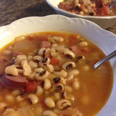 two bowls filled with soup on top of a table