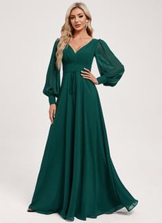 a woman in a long green dress with sleeves on her shoulders and an open back