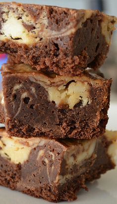 three brownies stacked on top of each other with white chocolate and oreo chips