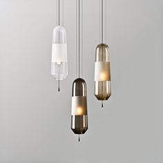 three pendant lights hanging from the ceiling in a room with white walls and flooring