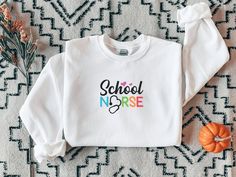 This multi-colored elementary school nurse sweatshirt is perfect for the first day of school. Your students will love greeting you on the first day of school in this cute and colorful sweatshirt. • 50% cotton, 50% polyester • Pre-shrunk • Classic fit • 1x1 athletic rib knit collar with spandex • Air-jet spun yarn with a soft feel and reduced pilling • Double-needle stitched collar, shoulders, armholes, cuffs, and hem This product is made especially for you as soon as you place an order, which is why it takes us a bit longer to deliver it to you. Making products on demand instead of in bulk helps reduce overproduction, so thank you for making thoughtful purchasing decisions! Highland Cow Gifts, Nursing School Gifts, Nursery Quotes, Colorful Sweatshirt, Sibling Outfits, Pug Shirt, Cow Gifts, School Nurse, The Sandlot