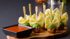 small appetizers with meatballs and sauce on a wooden board, ready to be eaten