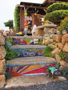 the steps are decorated with colorful tiles and plants