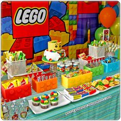 a lego themed birthday party complete with cupcakes, cake and candy buffet table