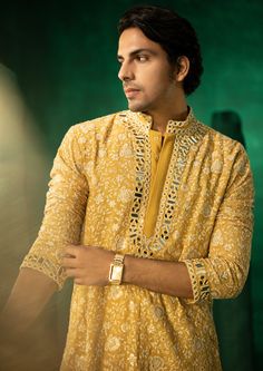 The garment is made in georgette, with chikankari embroidery patterns designed, embroidered and embellished with mirrorwork in house, and styled by the designers at our studio with the finest details. Designer Yellow Kurta With Chikankari Embroidery, Yellow Chanderi Sherwani With Chikankari Embroidery, Designer Yellow Sherwani With Dabka Work, Yellow Sherwani With Dabka Work For Designer Wear, Navratri Georgette Kurta With Mirror Work, Traditional Sherwani With Intricate Embroidery In Georgette, Traditional Georgette Sherwani With Intricate Embroidery, Straight Kurta With Chikankari Embroidery In Chinon, Traditional Chikankari Embroidered Georgette Kurta