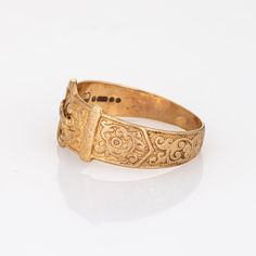 Stylish vintage buckle ring crafted in 9 karat yellow gold.   The stylish buckle ring features a charming scrolled design. Currently a size 10 1/2 (can be resized) the ring is great worn alone or stacked with your fine jewellery from any era. The buckle motif represents the joining of two lives together. The wide band (11mm - 0.43 inches) sits comfortably on the finger.   The ring is in good condition. We have not cleaned it in order to preserve the patina and collector value.     Particulars: Antique Engraved Ring With Decorative Band, Vintage Gold Engraved Ring, Vintage Yellow Gold Rings With Decorative Band, Antique Adjustable Yellow Gold Rings, Adjustable Antique Yellow Gold Rings, Vintage Gold Signet Ring With Intricate Design, Ornate Gold Signet Ring For Formal Occasions, Ornate Gold Signet Ring For Anniversary, Buckle Ring