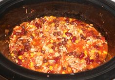 a crock pot filled with beans, corn and rice