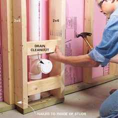 a man working on a wall with pink walls