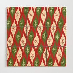 four square tiles with red, green and white designs on the front one has snowflakes