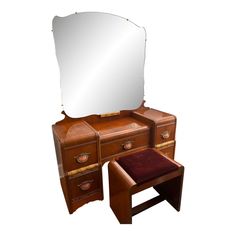 an antique wooden vanity with mirror and stool