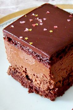 a piece of chocolate cake sitting on top of a white plate