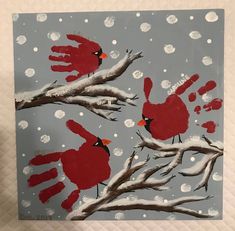 a painting of two red birds sitting on top of a tree branch in the snow