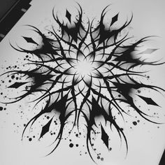 a black and white photo of an abstract design on a piece of paper with ink splatters