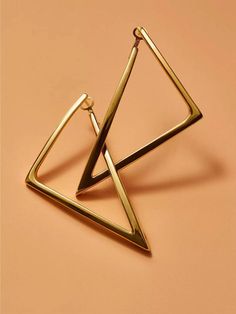 Structural gold earrings take on a geometric form. Roberto Coin signs each piece with a single ruby placed in a hidden position..18K yellow gold.Post and hinge back.Made in Italy.SIZE.Drop, about 2.75'.Width, about 1.5'.ABOUT THE BRAND.Jewelry designer Roberto Coin founded his eponymous line in 1996, with a strong emphasis on elegance and creative experimentation. Each piece is the result of a long creative process, taking inspiration from cultural influences and nature..Structural gold earrings take on a geometric form. Roberto Coin signs each piece with a single ruby placed in a hidden position.18K yellow goldPost and hinge backMade in ItalySIZEDrop, about 2.75'Width, about 1.5'ABOUT THE BRANDJewelry designer Roberto Coin founded his eponymous line in 1996, with a strong emphasis on eleg Roberto Coin Jewelry, Triangle Jewelry, Roberto Coin, Geometric Form, Brand Jewelry, Coin Jewelry, Jewelry Designer, Emphasis, Creative Process