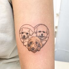 two dogs in a heart tattoo on the arm