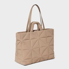 This Kate Tote Handbag from A New Day™ in a solid color showcases an unstructured silhouette with a geometric quilted finish for a chic, textured look and it goes well with any of your outfits. The interior accessories pocket, zip pocket and exterior side pockets help keep your belongings organized. Designed with a magnetic closure, this stylish tote handbag is easy to carry with double shoulder and grab handles. A New Day™: Style that goes wherever you do. Versatile Quilted Beige Bag, Beige Quilted Shoulder Bag For Shopping, Versatile Quilted Everyday Bag, Textured Tote Shoulder Bag For Travel, Textured Travel Tote Shoulder Bag, Chic Everyday Bag With Geometric Shape, Quilted Double Handle Bag For Everyday, Everyday Textured Tote Bag, Quilted Double Handle Bag