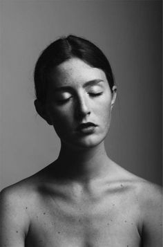 a black and white photo of a woman with her eyes closed