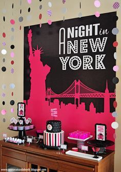 a table topped with cakes and cupcakes next to a sign that says night in new york