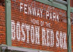 an old brick building with the word boston painted on it's side in white