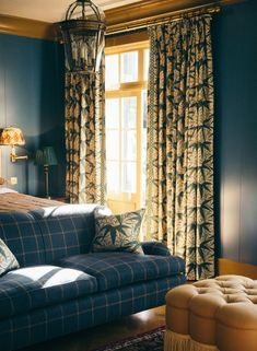 a living room with blue walls and curtains