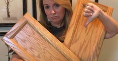 a woman holding up some wood pieces in front of her face