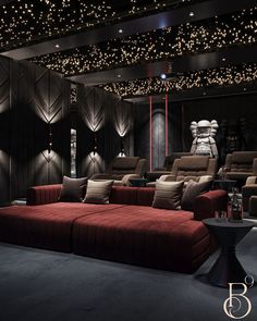 a room that has some couches and lights on the ceiling in it, with two recliners sitting next to each other