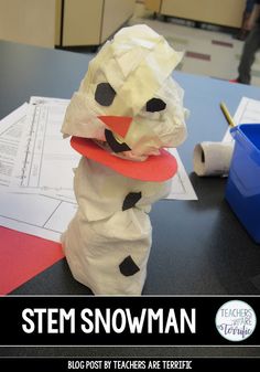 a snowman made out of toilet paper sitting on top of a table