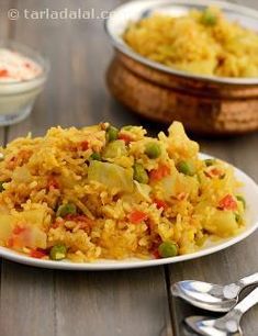 a white plate topped with rice and vegetables