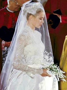 a woman in a wedding dress standing next to a man