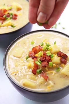 two bowls filled with soup and topped with bacon